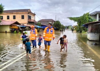 ANGGOTA APM Kelantan memberikan nasihat kepada kanak-kanak yang bermain air banjir di Kampung Bagus, Rantau Panjang, Kelantan-UTUSAN/ROHANA ISMAIL.