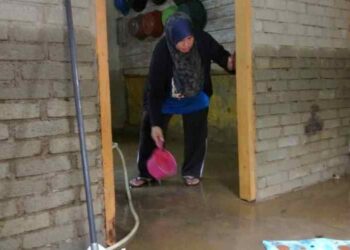 PENDUDUK membersihkan kediamannya selepas banjir mulai surut di Kampung Pasir Raja, Hulu Dungun, Dungun, semalam. – UTUSAN/NIK NUR IZZATUL HAZWANI NIK ADNAN.