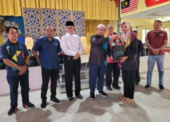 ZAMRI Zainal Abidin (empat dari kiri) ketika menyampaikan bantuan YADIM kepada mangsa-mangsa banjir di PPS SMK Keroh di Kuala Krai, Kelantan hari ini. UTUSAN/MUSTAQIM MOHAMED