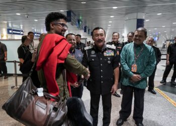 RUSLIN Jusoh beramah mesra dengan pelancong dari India ketika meninjau Pelan Liberalisasi Visa di KLIA. - UTUSAN/FAISOL MUSTAFA