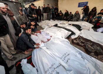 DERETAN mayat penduduk Palestin ditutupi kain memenuhi pekarangan sebuah hospital di Rafah, selatan Semenanjung Gaza. - AFP 