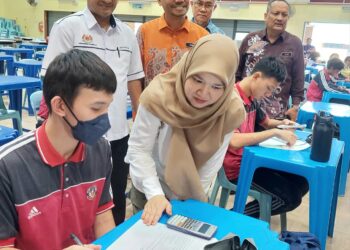 FADHLINA Sidek menyapa seorang calon SPM yang sedang mengulang kaji pelajaran ketika turun padang melawat SMK Seri Nibong di Nibong Tebal, Pulau Pinang, hari ini.