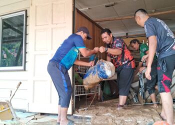 SEBAHAGIAN guru yang menyertai gotong-royong membersihkan lumpur akibat banjir di SK Kampung Shukor, hari ini. - UTUSAN/NIK NUR IZZATUL HAZWANI NIK ADNAN