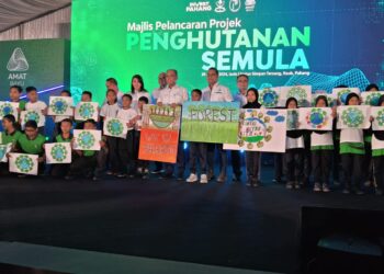 WAN ROSDY Wan Ismail (tengah) bersama pelajar Sekolah Kebangsaan (SK) Tersang yang mempamerkan lukisan bertema hutan sempena Pelancaran Projek Penghutanan Semula Hutan Simpanan Kekal di Raub, Pahang. - UTUSAN/SALEHUDIN MAT RASAD