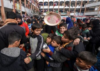 KANAK-kanak Palestin berkumpul untuk menerima makanan di sebuah sekolah kerajaan di Rafah, selatan Gaza.-AFP