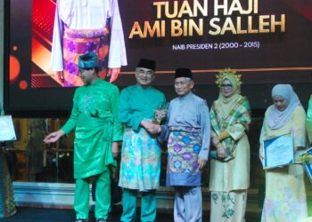 MOHD. ALI Mohd. Rustam menyampaikan Anugerah Pemimpin Inspirasi Perdasama kepada penerima, Ami Salleh pada Majlis Makan Malam Perdasama di sebuah hotel di Jalan Hang Tuah, Melaka. - UTUSAN/AMRAN MULUP