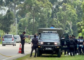 Anggota polis berkawal di kawasan jumpa mayat dalam longkang di Kampung Seribong, Pasir Tumboh hari ini.