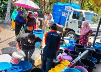 PENDUDUK kampung beratur mengambil air di tangki statik di sebuah masjid di Kampung Kuala Papar, Sabah semalam.
