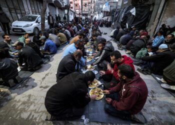 PENDUDUK Palestin menyertai jamuan berbuka puasa anjuran anggota kem pelarian Barbara, di sepanjang kawasan jalan di Rafah di selatan Semenanjung Gaza.-AFP