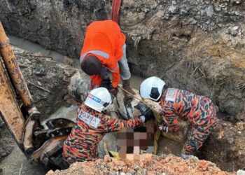 ANGGOTA bomba mengeluarkan mayat jurukimpal yang tertimbus ketika melakukan kimpalan batang besi paip air berhampiran Ladang Bukit Benut, Kluang.