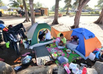 SEORANG wanita yang masih dalam tempoh berpantang nekad tinggal di dalam khemah di tepi pantai di Port Dickson bersama dua anak perempuannya setelah menghadapi masalah keluarga.-UTUSAN/MOHD. SHAHJEHAN MAAMIN