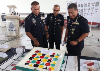 MOHAMED Usuf Jan Mohamed (kiri) melihat sebahagian daripada peralatan judi yang dirampas dalam 14 serbuan berasingan ketika sidang akhbar di IPK Pulau Pinang.-UTUSAN/IQBAL HAMDAN