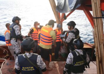 ANGGOTA Maritim Malaysia Kelantan melakukan pemeriksaan keatas sebuah bot nelayan di kawasan perairan Malaysia di Kelantan semalam-UTUSAN/KAMARUL BISMI KAMARUZAMAN.