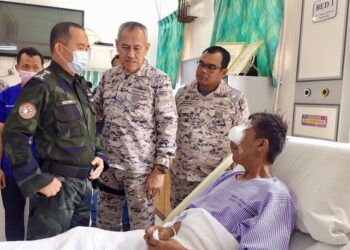VICTOR Sanjos (kiri)  semasa melawat anggota Maritim Malaysia yang cedera akibat insiden berbalas tembakan di perairan Kunak, Sabah, baru-baru ini.