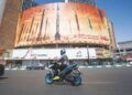 SEORANG lelaki menunggang motosikal melepasi papan iklan yang menggambarkan peluru berpandu balistik Iran di Tehran, semalam. -AFP