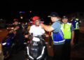 MOHD. Misuari Abdullah (kanan) memakaikan topi keledar kepada salah seorang pengguna jalan raya semasa melakukan pemeriksaan motosikal pada Penutup Operasi Penguatkuasaan HRA 2024 di Akademi Pengangkutan Jalan Wilayah Timur, Kota Bharu, Kelantan sebentar tadi-UTUSAN/KAMARUL BISMI KAMARUZAMAN.