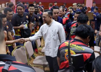 STEVEN Sim (tengah) beramah mesra bersama anggota bomba sukarela ketika hadir menyampaikan sumbangan tajaan caruman SKSPS oleh Perkeso kepada 218 anggota persatuan itu di pejabat Perkeso Seberang Jaya, Pulau Pinang.-UTUSAN/IQBAL HAMDAN