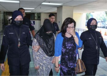 SAFIAH Ibrahim (berbaju biru) dan Zarina Sinin dibawa ke Mahkamah Seksyen Ampang, semalam bagi menghadapi pertuduhan melakukan rompakan berkumpulan menggunakan senjata ke atas seorang lelaki. 
– UTUSAN/AMIR KHALID