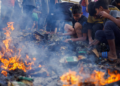 PENDUDUK Palestin mencari makanan di antara serpihan yang terbakar selepas serangan Israel ke atas kawasan yang ditetapkan untuk pelarian, di Rafah di selatan Gaza pada  27 Mei lalu. -REUTERS