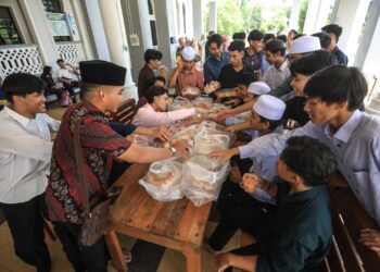 PELAJAR  mengambil makanan dan minuman yang disediakan oleh ibu bapa pelajar selepas mengambil SPM 2023 di SMIYT Kuala Terengganu, hari ini. - UTUSAN/PUQTRA HAIRRY ROSLI