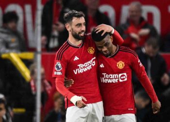 Amad Diallo (kanan) diraikan rakan sepasukan, Bruno Fernandes selepas menjaringkan gol menentang Newcastle United di Old Trafford, pagi ini. - AFP