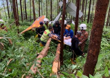 ANGGOTA bomba mengeluarkan mangsa dalam pesawat ringan yang terhempas di ladang kelapa sawit dekat Felda Gunung Besout 2 Tambahan di  Sungkai hari ini. - UTUSAN/IHSAN JBPM