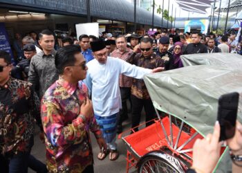 ANWAR Ibrahim (tengah) ketika melakukan 'walkabout' sempena Majlis Penutup Program Madani Rakyat 2024 Zon Utara, di Tapak Pesta Sungai Nibong, Gelugor, Pulau Pinang.-UTUSAN/IQBAL HAMDAN