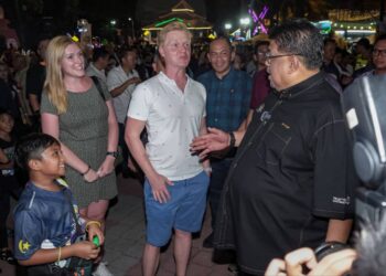 AB. RAUF Yusoh berbual dengan pelancong asing ketika Majlis Pelancaran Melaka Bila Larut Malam di hadapan Bangunan Stadthuys, Banda Hilir, Melaka. - UTUSAN/SYAFEEQ AHMAD