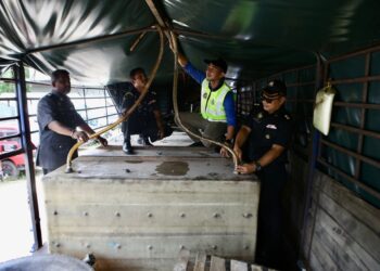 MUHAMMAD Nizam Jamaludin (dua kanan) bersama pegawai KPDN menunjukkan tangki dan peralatan memindahkan minyak dalam sebuah treler yang dirampas kerana menyeleweng diesel di Kubang Pasu. -UTUSAN/ SHAHIR NOORDIN
