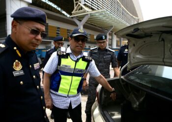 AEDY Fadly Ramli (tengah) menunjukkan tangki yang diubahsuai pada kenderaan asing yang menyeludup diesel dalam Op Tangki di Kompleks ICQS Bukit Kayu Hitam. - UTUSAN/ SHAHIR NOORDIN