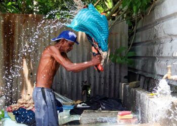 SEORANG pekerja dobi tradisional membersihkan pakaian dengan cara mengosok dan memukulnya di atas batu di Dhobi Ghat yang terletak antara Jalan Air Hitam dan Jalan York, George Town, Pulau Pinang. - MINGGUAN/IQBAL HAMDAN
