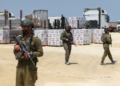 TENTERA Israel memeriksa bantuan kemanusiaan, di tengah-tengah konflik berterusan di Gaza antara Israel dan kumpulan Islam Palestin Hamas, berhampiran titik Erez Crossing di utara Gaza, semalam. -REUTERS