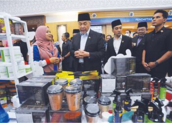 AHMAD ZAHID Hamidi diiringi On Hafiz Ghazi, melawat gerai pameran sempena Halal On Track di Pusat Konvensyen Antarabangsa Persada Johor, Johor Bahru, semalam. – UTSUAN/RAJA JAAFAR ALI
