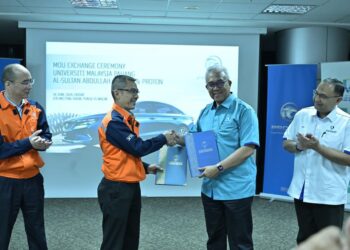 Dr Yuserrie Zainuddin bertukar dokumen MoU dengan Amran Mohd Tomin di Proton Tanjung Malim baru-baru ini