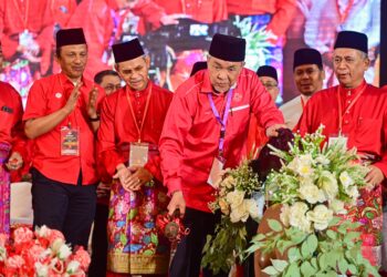 AHMAD Zahid Hamidi (tengah) memukul gong sebagai gimik perasmian pada Majlis Perasmian Mesyuarat UMNO Bahagian Kuala Nerus di Kuala Nerus, hari ini. - UTUSAN/PUQTRA HAIRRY ROSLI