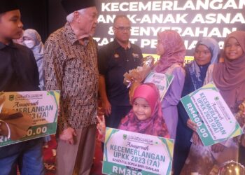 ABDUL Aziz Sheikh Ab Kadir beramah mesra dengan para penerima pada Majlis Anugerah Kecemerlangan Anak Asnaf MAINS dan Penyerahan Zakat Perniagaan di Seremban-UTUSAN/NUR SHARIEZA ISMAIL