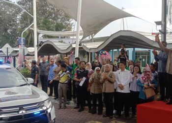 MOHAMMAD Nizar Jamaluddin (kanan) melepaskan konvoi Jalur Gemilang negeri Perak di Dataran Putra, Lumut, hari ini. - UTUSAN
