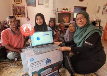 WAN Zalilah Shafie (kanan) menyampaikan sumbangan komputer riba dan mesin pencetak beserta sumbangan zakat kepada Nur Aleesa Nizar (dua dari kiri) di kediaman pelajar itu di Jalan Tanjong Kuala, Tumpat, Kelantan hari ini - UTUSAN/MUSTAQIM MOHAMED