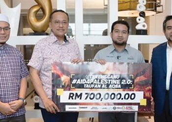 MUHAMMAD Nadir Al-Nuri Kamaruzaman (dua, kanan) menerima replika cek sumbangan daripada Ahmad Samsuri Mokhtar (dua, kiri) untuk membantu rakyat Gaza di Putrajaya, baru-baru ini.