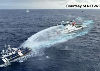 This handout taken and released on December 4, 2024 by the National Task Force for the West Philippine Sea (NTF-WPS) shows a China Coast Guard ship (R) deploying water cannon at the Phillipine Bureau of Fisheries and Aquatic Resources (BFAR) vessel BRP Datu Pagbuaya (L) near Scarborough Shoal in disputed waters of the South China Sea. The Philippines said the China Coast Guard fired water cannon December 4 on a government vessel during a maritime patrol near the disputed Scarborough Shoal. (Photo by Handout / National Task Force for the West Philippine Sea (NTF-WPS) / AFP) / RESTRICTED TO EDITORIAL USE - MANDATORY CREDIT "AFP PHOTO / National Task Force for the West Philippine Sea (NTF-WPS)" - NO MARKETING NO ADVERTISING CAMPAIGNS - DISTRIBUTED AS A SERVICE TO CLIENTS
