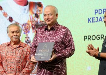 SULTAN NAZRIN SHAH (tengah) berkenan melancarkan Buku Coffee Table PDRM di Hotel Mandarin Oriental, Kuala Lumpur, hari ini. Turut sama, Razarudin Husain (kanan). - UTUSAN/FARIZ RUSADIO