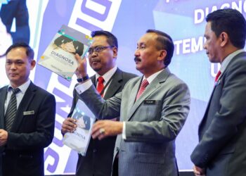 RUSLIN menunjukkan buku 'Diagnosa' yang dilancarkan beliau sempena Majlis Amanat Ketua Pengarah AADK di Ibu Pejabat Agensi Anti Dadah Kebangsaan (AADK), Sungai Merab di sini, hari ini.- MUHAMAD IQBAL ROSLI/UTUSAN