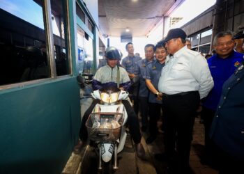 SHAMSUL Azri Abu Bakar (kanan) beramah mesra bersama penunggang motosikal warga Thailand yang sedang memasuki sempadan malaysia semasa meninjau pengoperasian di Kompleks Imigresen, Kastam, Kuarantin dan Keselamatan (ICQS) Rantau Panjang, Kelantan selepas peluncuran Program rintis Agensi Kawalan dan Perlindungan Sempadan (AKPS) Malaysia.- UTUSAN /KAMARUL BISMI KAMARUZAMAN
