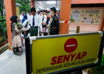 PELAJAR berbaris memasuki dewan untuk menduduki peperiksaan SPM di SMK Kampong Pasir Puteh, Ipoh hari ini. - UTUSAN/MUHAMAD NAZREEN SYAH MUSTHAFA