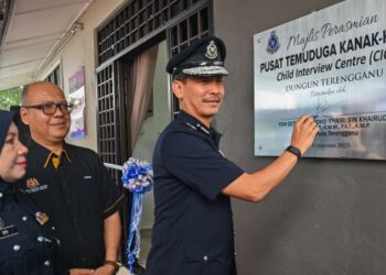 MOHD. Khairi Khairudin (kanan) menurunkan tanda tangan pada plak sempena Majlis Perasmian Pusat Temuduga Kanak-Kanak (CIC) di Jalan Teluk Lipat, Dungun, Terengganu. – UTUSAN/PUQTRA HAIRRY