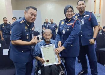 SITI ROHANI Nadir (dua dari kanan) menyampaikan sijil penghargaan kepada pesara bomba, Nordin Seran pada Majlis Perhimpunan Bulanan di Ibu pejabat JBPM Johor di Johor Bahru.