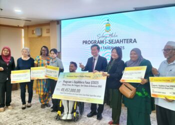 CHOW Kon Yeow (tengah) menyampaikan sumbangan kepada para penerima bantuan kebajikan i-Sejahtera di George Town, Pulau Pinang.