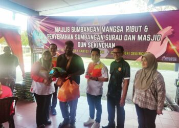 NG SUEE Lim menyerahkan sumbangan kepada penerima pada program itu di Dewan Seri Sekinchan, Sabak Bernam, Selangor hari ini. UTUSAN/ ISKANDAR SHAH MOHAMED