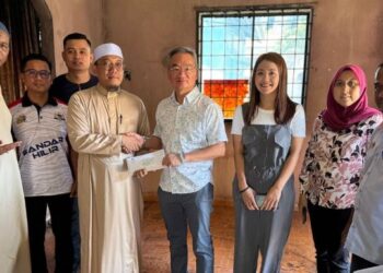 KHOO Poay Tiong menyampaikan sumbangan sebanyak RM2,000 ketika melakukan lawatan ke rumah Muhammad Ghazali di Banda Hilir, Melaka, hari ini. - UTUSAN/AMRAN ALI