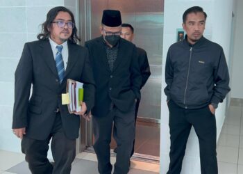 TERTUDUH (dua dari kiri) dibawa masuk ke Kompleks Mahkamah Kangar, Perlis, bagi menghadapi pertuduhan menipu pasangan suami isteri pada 17 Mac 2021. -UTUSAN/ASYRAF MUHAMMAD